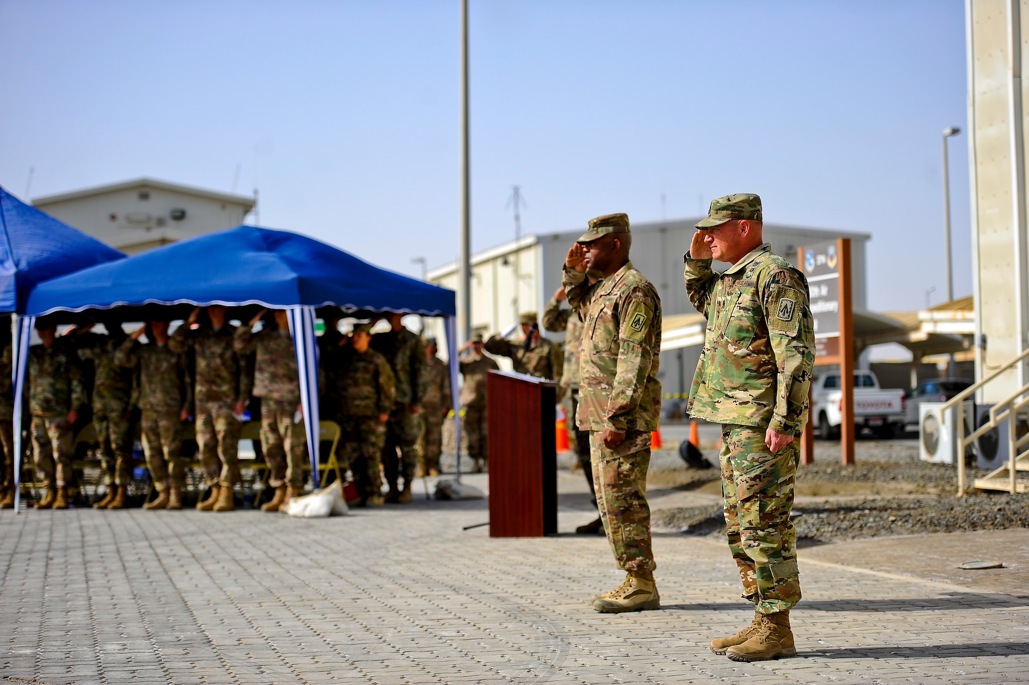 U.S. Army Command Sgt. Maj. Robert Bell and Command Sgt. Maj. Robert Walker salute the soldiers of the 1st Battalion, 7th Air Defense Artillery as the honor guard presents the nation's colors and battalion colors during the change of responsibility ceremony at Al Dhafra Air Base, United Arab Emirates, March 11, 2018. The 1st Battalion, 7th Air Defense Artillery Regiment was first constituted on March 8, 1898 at Fort Slocum, New York. 

 (U.S. Air Force photo by Tech. Sgt. Anthony Nelson Jr)