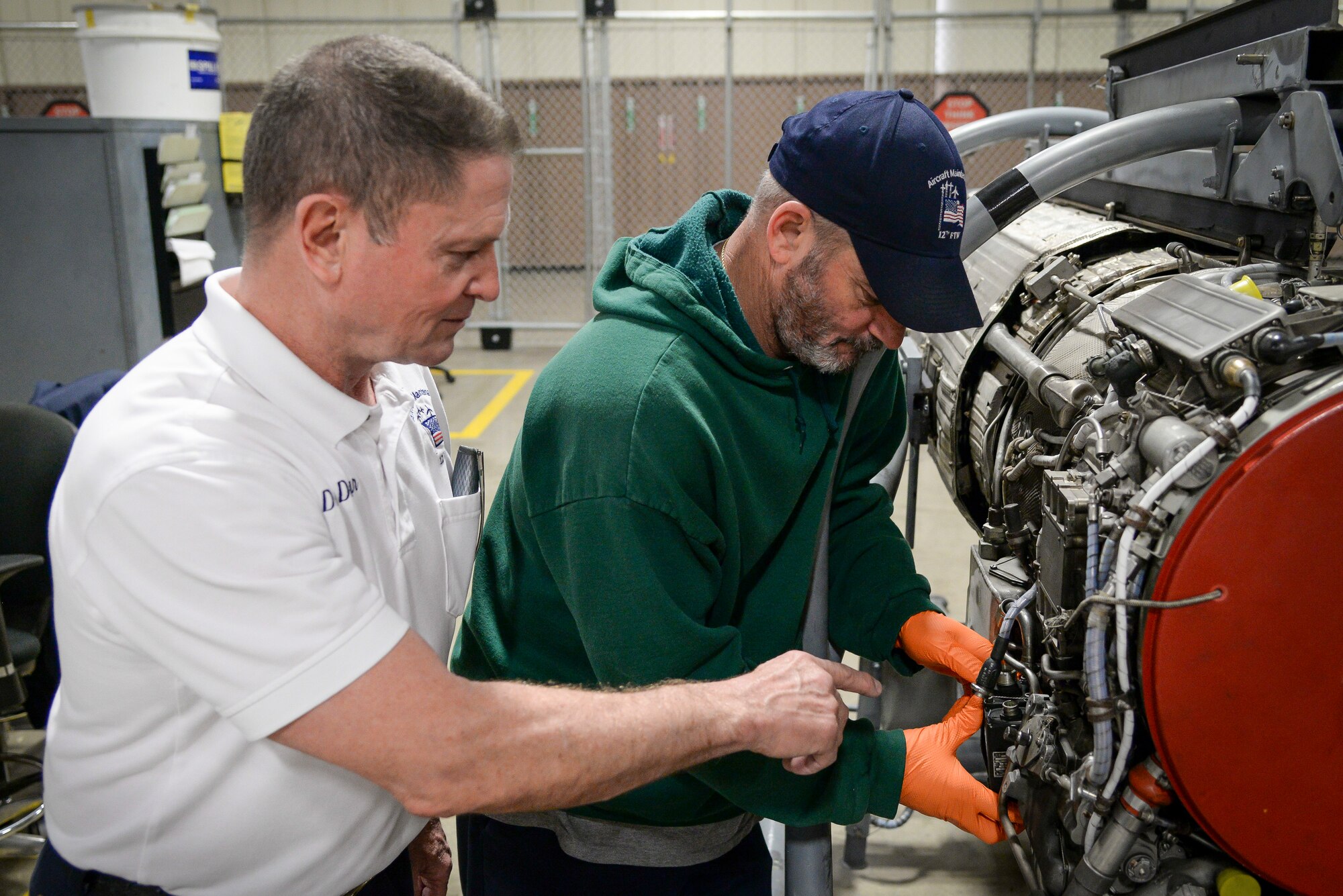 Dave Duggar, 12th Maintenance Group J-85 propulsion shop supervisor, works with James Schottler, jet engine mechanic, on a T-38 Talon engine Feb. 28 2018, at Joint Base San Antonio-Randolph, Texas.  Duggar oversees the engine shop and test cell ensuring T-38 engines are "mission ready" to conduct daily sorties for the 12th Flying Training Wing. (U.S. Air Force photo by Sean M. Worrell)