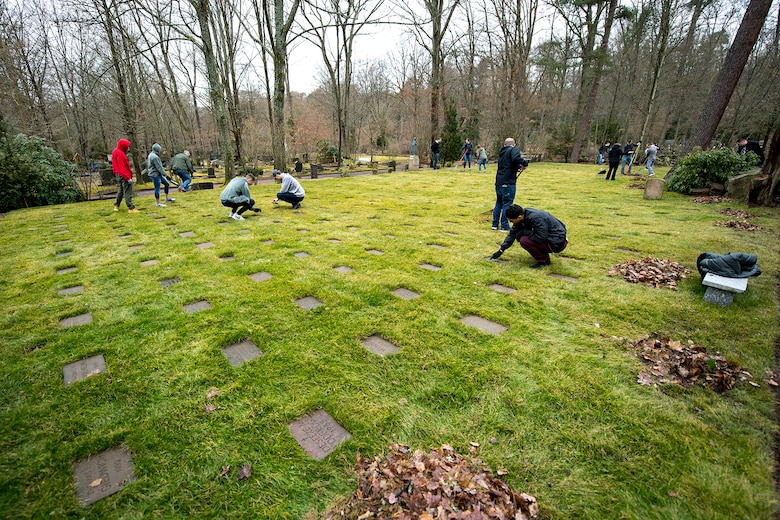Kaiserslautern Military Community members work together to clean the American Kindergraves in Kaiserslautern, Germany, March 10, 2018. After an agreement with the cemetery management, the Ramstein Area Chief’s Group and the German-American Women’s Organization took over the responsibilities for the lease. (U.S. Air Force photo by Senior Airman Devin Boyer)