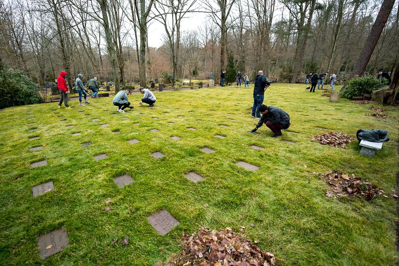 Kaiserslautern Military Community members work together to clean the American Kindergraves in Kaiserslautern, Germany, March 10, 2018. After an agreement with the cemetery management, the Ramstein Area Chief’s Group and the German-American Women’s Organization took over the responsibilities for the lease. (U.S. Air Force photo by Senior Airman Devin Boyer)