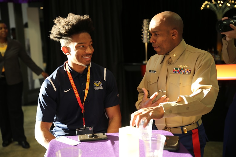 Maj. Paul Smith speaks to Devon Teagle about life goals and perseverance during at the 2018 Mid-Eastern Athletic Conference (MEAC) Marine Corps Battles Won Symposium Reception in Norfolk, Virginia, March 9. Teagle, a native of Abingdon, MD, and senior at Coppin State University is one of the 26 recipients of the U.S. Marines Leadership Awards recognized for his outstanding leadership in athletics, in the classroom and in his community. Smith is the strategic plans officer for 4th Marine Aircraft Wing, Marine Forces Reserve.