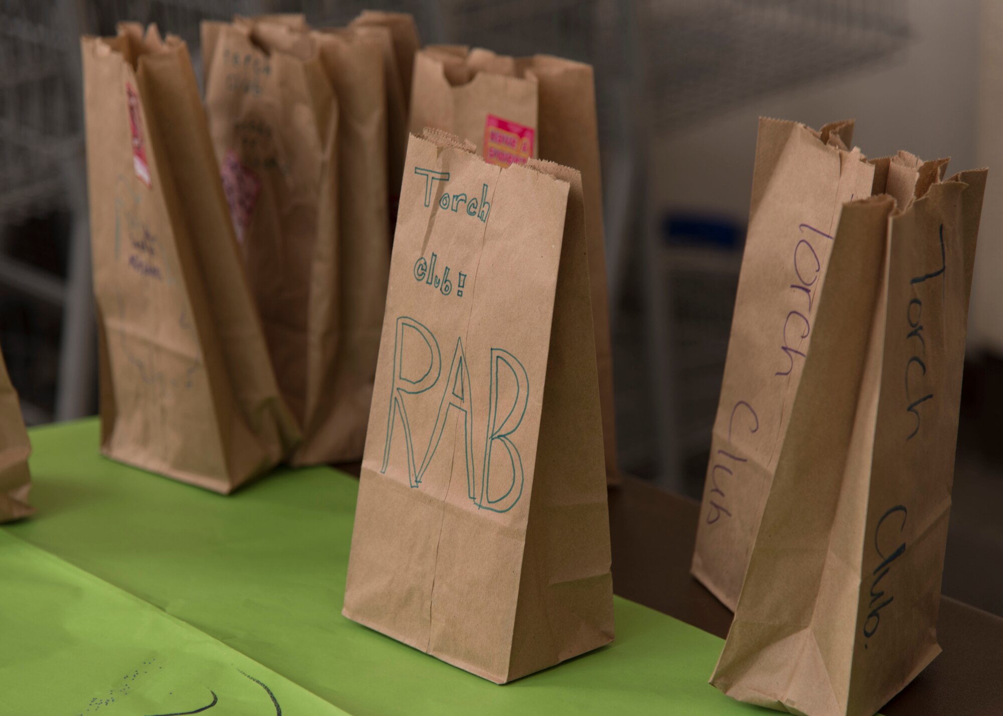 Gift bags decorated by members of Ramstein’s Boys and Girls Club of America Torch Club are handed out on Ramstein Air Base, Germany, March 7, 2018. These small bags, containing gardening accessories, candy, and more, were used to show acts of kindness and to give back to the community. (U.S. Air Force photo by Airman 1st Class Kaylea Berry)