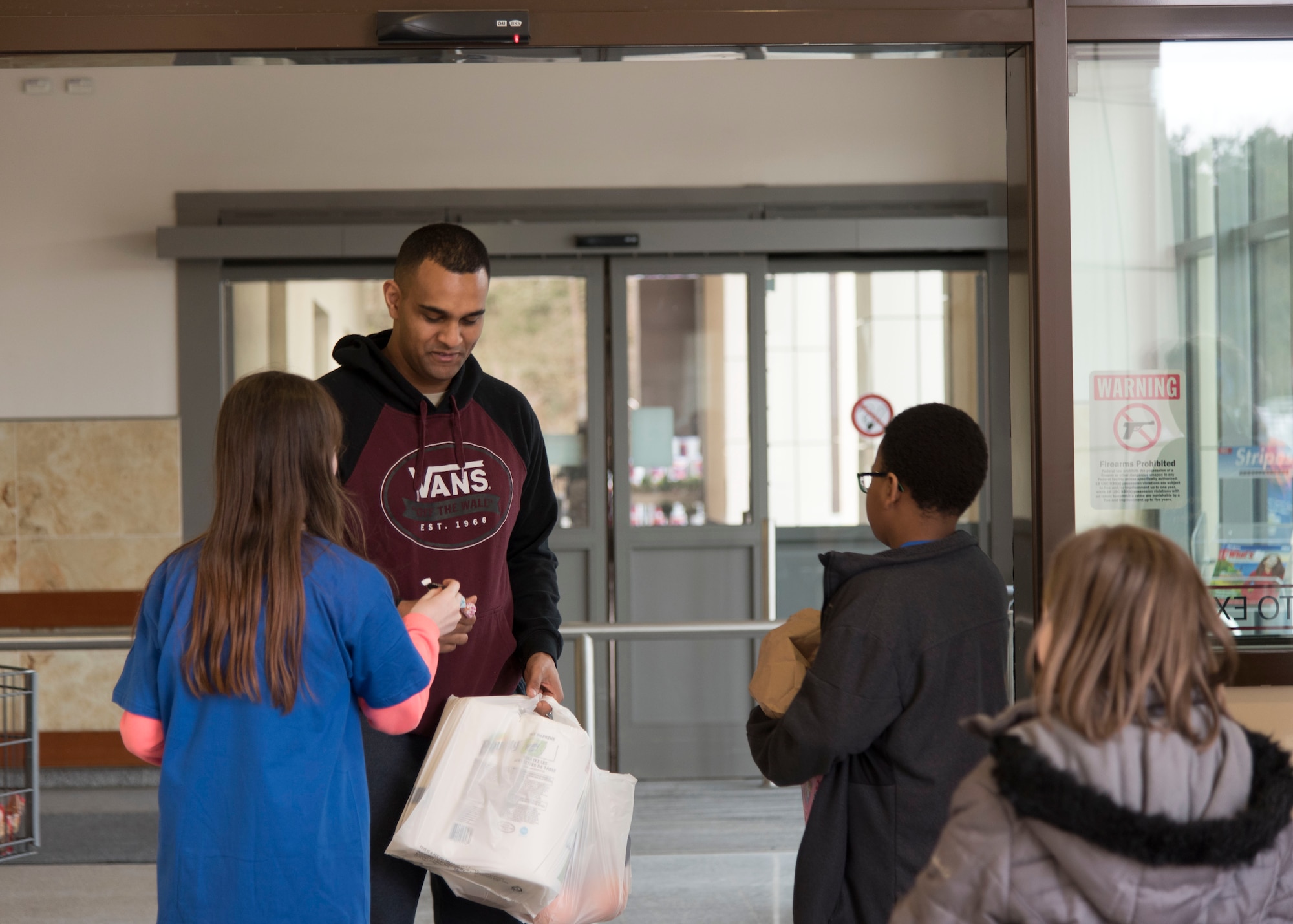 Members of Ramstein’s Boys and Girls Club of America Torch Club greet customers as they come out of the commissary with “seeds of kindness” on Ramstein Air Base, Germany, March 7, 2018. The young members were eager to impact other’s lives in a positive way by handing out small gestures of selflessness. (U.S. Air Force photo by Airman 1st Class Kaylea Berry)