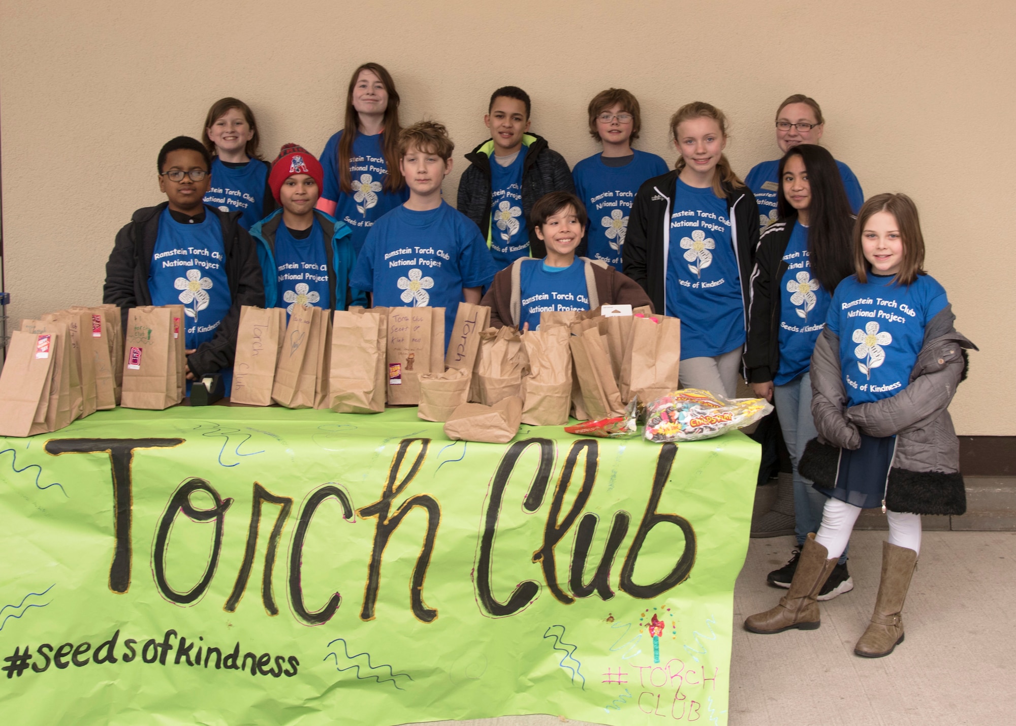 Members of Ramstein’s Boys and Girls Club of America Torch Club pose for a group photo on Ramstein Air Base, Germany, March 7, 2018. The Torch Club planted “seeds of kindness” at the Ramstein Base Commissary to give back to the community. This was their first national project as a group. The Torch Club meets on Wednesdays at the Youth Programs building from 4:00 p.m. - 5:00 p.m. (U.S. Air Force photo by Airman 1st Class Kaylea Berry)
