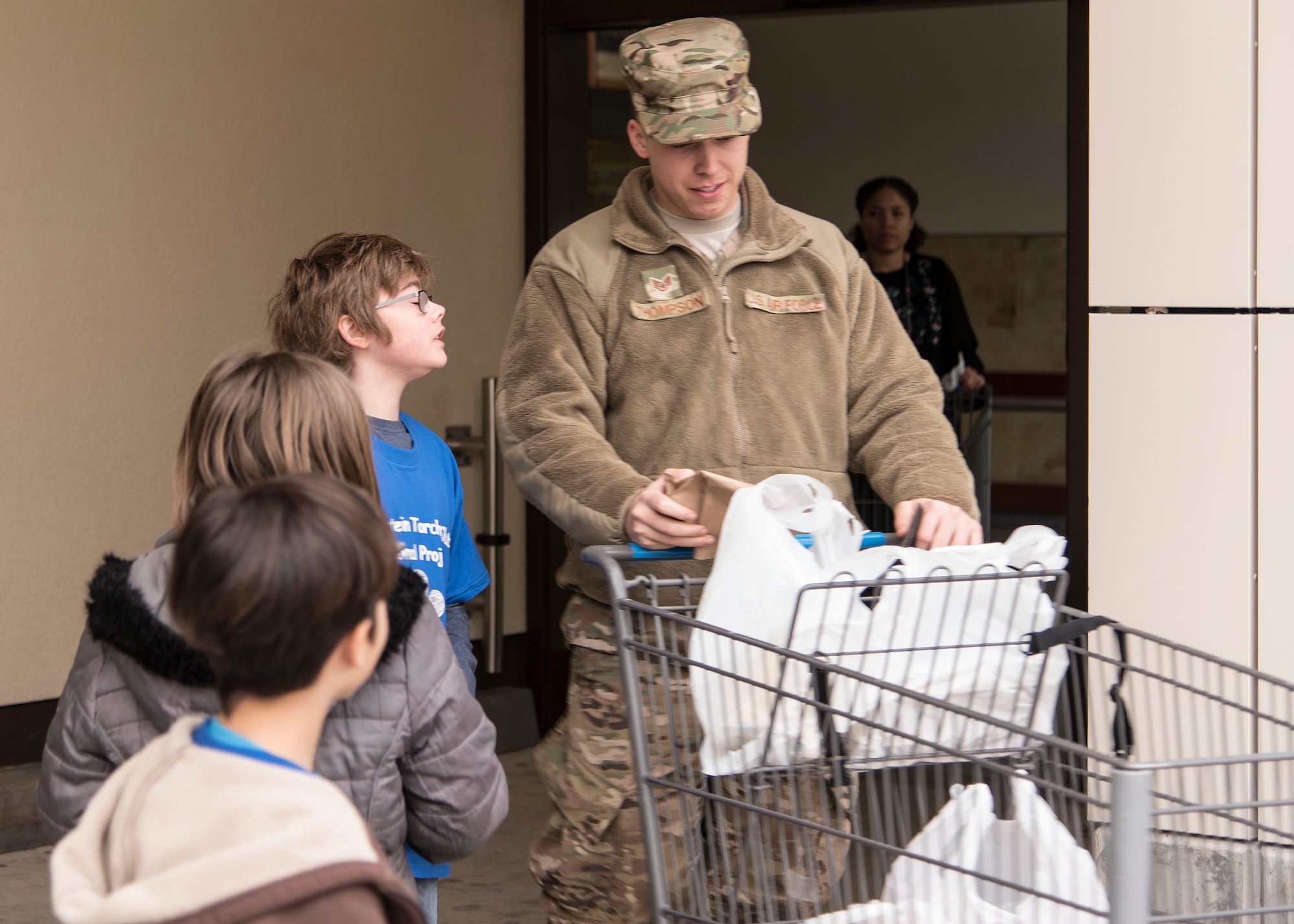 Members of Ramstein’s Boys and Girls Club of America Torch Club plant “seeds of kindness” by handing out compliments, family themed bags, handmade cards, and more to commissary customers on Ramstein Air Base, Germany, March 7, 2018. The club itself is centered on building character and leadership amongst youth ages 9-12. (U.S. Air Force photo by Airman 1st Class Kaylea Berry)