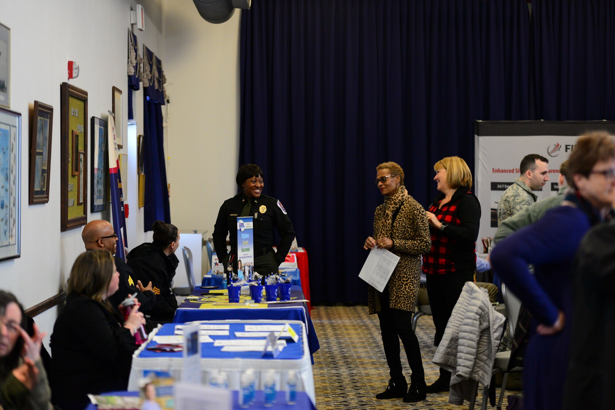Team Dover spouses visit with various employers during the career information fair segment of the second annual Spouse Symposium March 7, 2018, at Dover Air Force Base, Del. Approximately 20 local employers attended the career information fair to explain employment opportunities to Team Dover spouses. (U.S. Air Force photo by Staff Sgt. Aaron J. Jenne)
