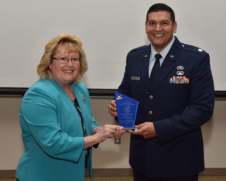 Cynthia Abbott, the director of Logistics and Logistics Services presents Major Jose Perez IV with a Logistics award. Perez was one of many individuals honored for outstanding achievement. (U.S. Air Force photo / Michelle Gigante)
