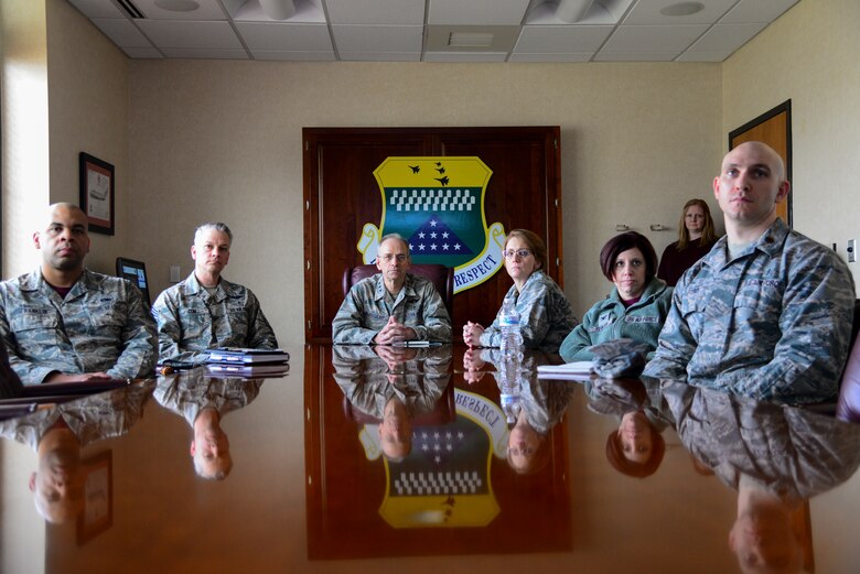 Representatives from Air Force Mortuary Affairs Operations and the 436th Medical Group join Air Force Surgeon General Lt. Gen. (Dr.) Mark Ediger (center) and Chief Master Sgt. George Cum (second from the left), Air Force Surgeon General medical enlisted force and enlisted corps chief, for a briefing about the AFMAO mission March 9, 2018, at Dover Air Force Base, Del. Ediger visited AFMAO, the Armed Forces Medical Examiner System, and held an all call for members of the 436th MDG during his visit. (U.S. Air Force photo by Staff Sgt. Aaron J. Jenne)