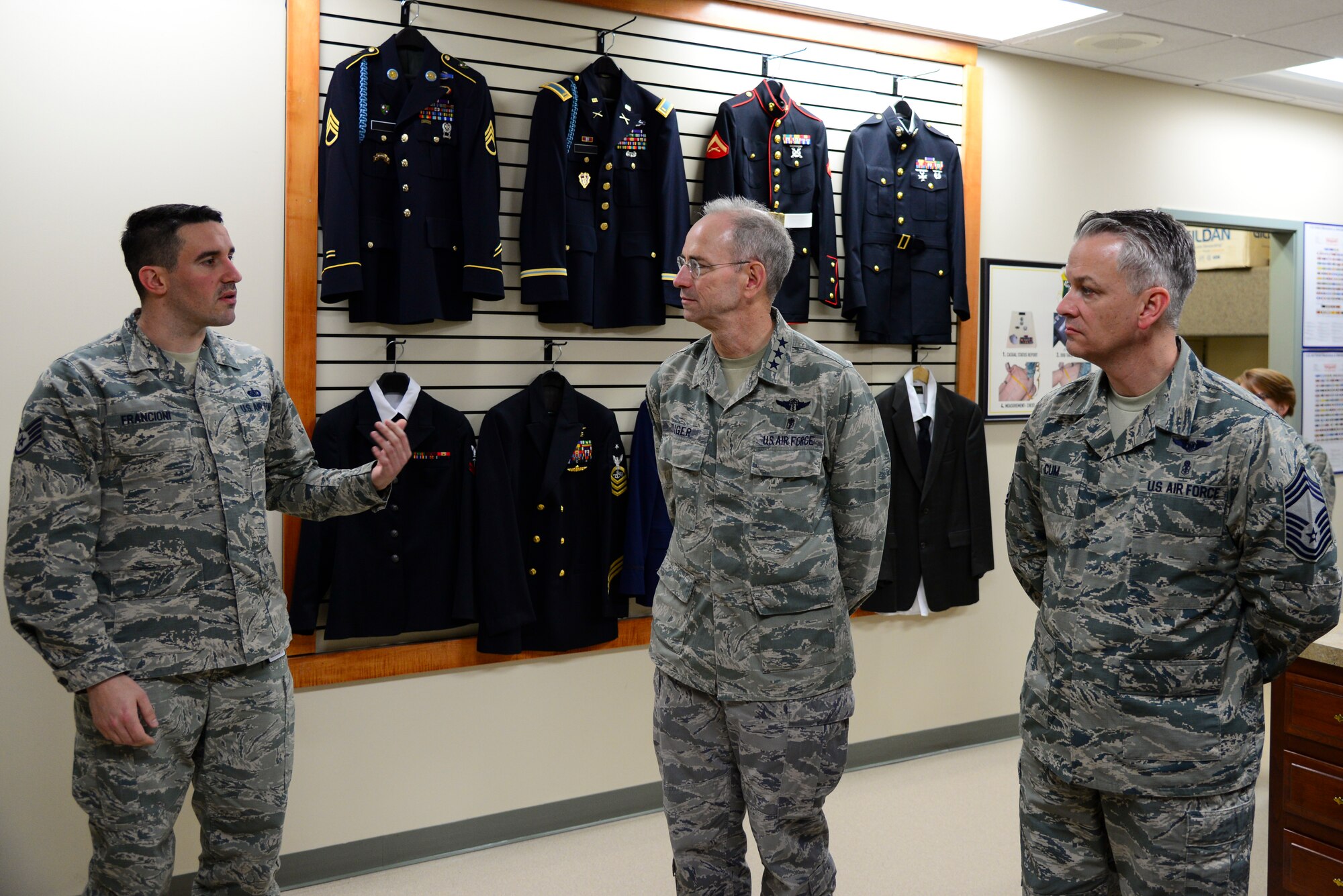 Staff Sgt. Giuseppe Francioni, Air Force Mortuary Affairs Operations NCO in charge of the Joint Services Uniforms Section, briefs Air Force Surgeon General Lt. Gen. (Dr.) Mark Ediger and Chief Master Sgt. George Cum, Air Force Surgeon General medical enlisted force and enlisted corps chief, during an orientation of AFMAO March 9, 2018, at Dover Air Force Base, Del. Airmen assigned to AFMAO briefed Ediger about how they care for the remains of fallen service members with dignity and respect. (U.S. Air Force photo by Staff Sgt. Aaron J. Jenne)