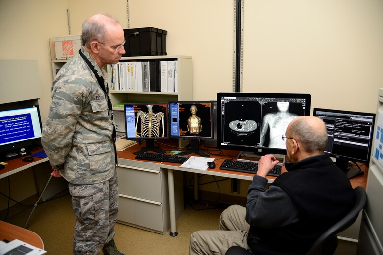 Dr. Howard Harcke (right), Armed Forces Medical Examiner System chief forensic radiologist, shows diagnostic images to Surgeon General Lt. Gen. (Dr.) Mark Ediger during a tour March 9, 2018, at Dover Air Force Base, Del. Harcke, a retired Army colonel, and his team use these images to help field medics understand the effectiveness of combat lifesaving techniques. (U.S. Air Force photo by Staff Sgt. Aaron J. Jenne)