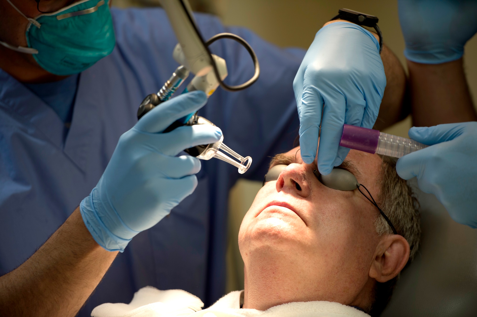 A dermatology patient prepares to receive laser treatment on his nose at MacDill Air Force Base, Fla., March 9, 2018. The MacDill dermatology clinic gained new capabilities to treat scars and burns. (U.S. Air Force photo by Senior Airman Rito Smith)