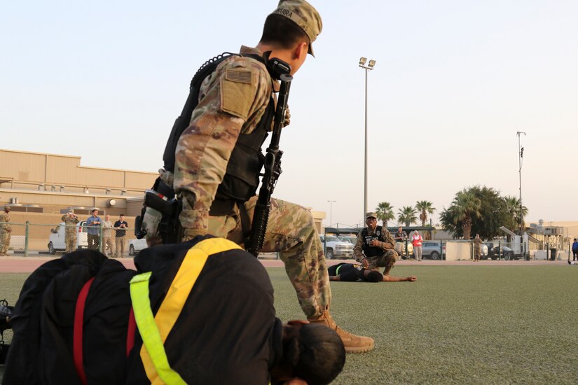 Private First Class Christian Ibarra, military police, 202nd Military Police Company, yells to Spc. Jeremiah Matthews, 202nd MP Co., during an active shooter and mass casualty drill, Camp Arifjan, Kuwait, March 7, 2018. The exercise tested first responders and other emergency services that would be crucial during a real-world emergency.