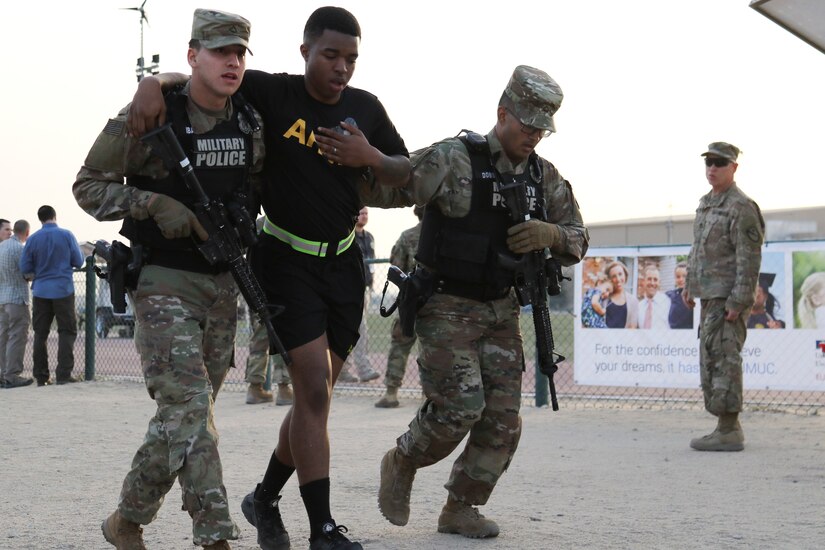Private First Class Christian Ibarra, left, and Pfc. Matthew Dobson, both military police with the 202nd Military Police Company, escort a simulated victim of a mass shooting to a casualty collection point, Camp Arifjan, Kuwait, March 7, 2018. The exercise tested first responders and other emergency services that would be crucial during a real-world emergency.