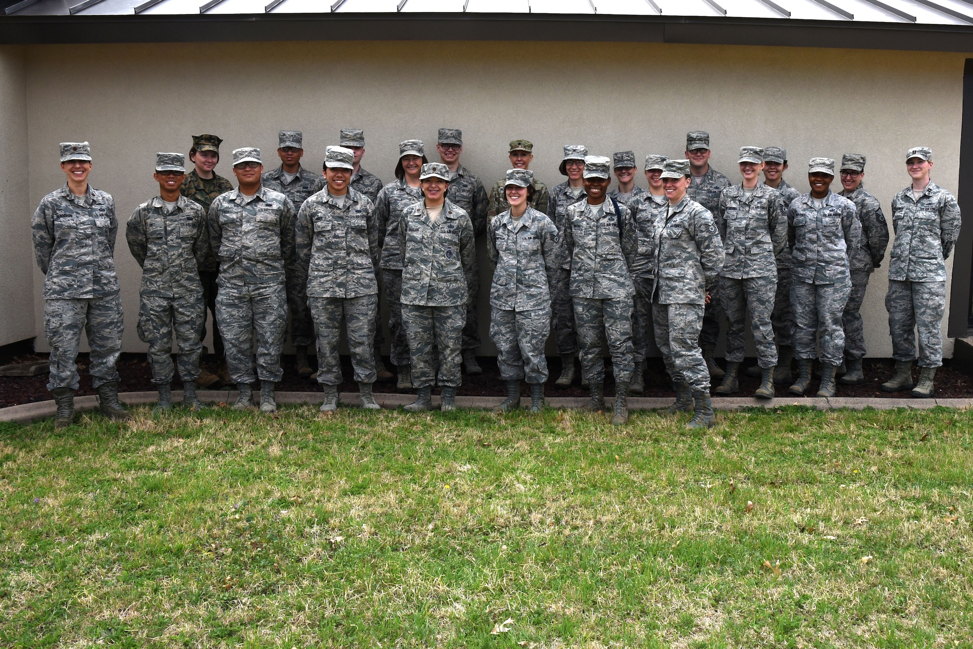 Mentors and mentees take a moment for a picture before heading back to work after the speed mentoring event hosted by the 17th Force Support Squadron at the Airman Family Readiness Center on Goodfellow Air Force Base, Texas, March 12, 2018. In recognition of Women’s History Month, service members were invited to attend a mentoring session with various military members stationed at Goodfellow. (U.S. Air Force photo by Airman 1st Class Seraiah Hines/Released)