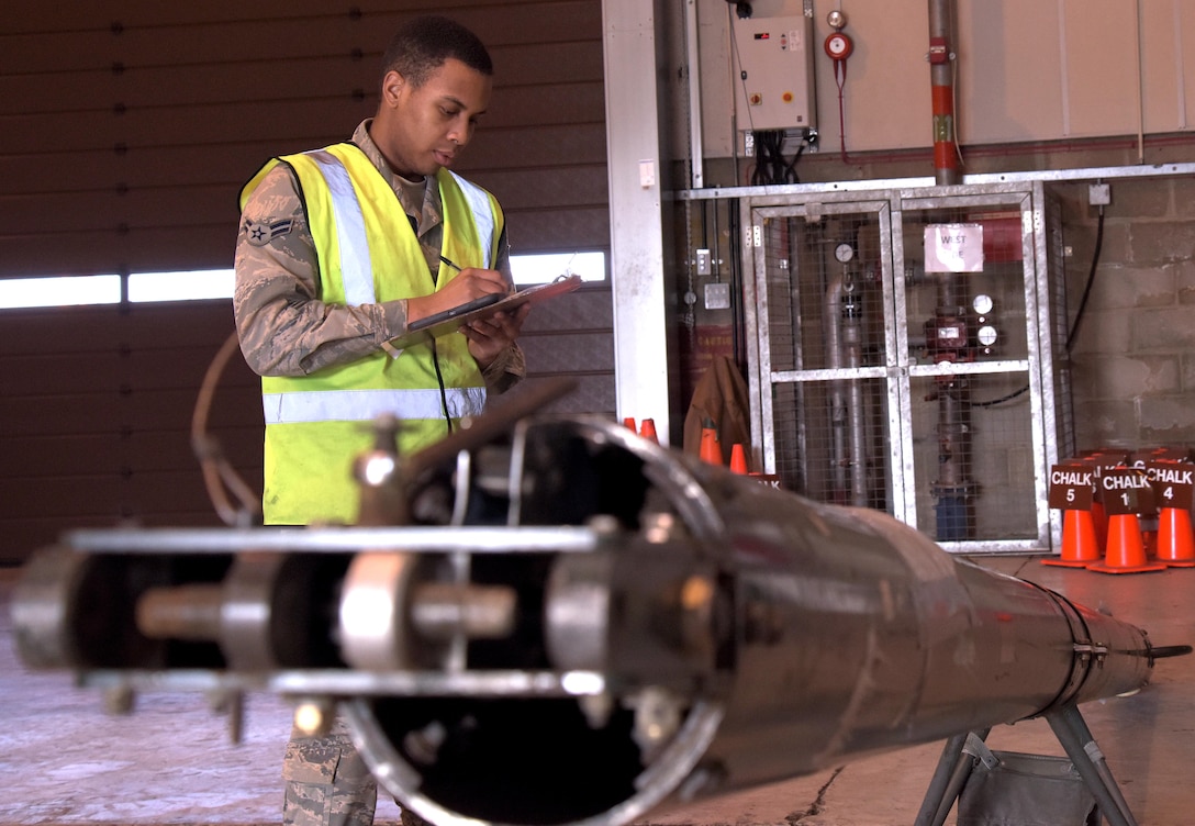 U.S. Air Force Airman 1st Class Daniel Johnson, 100th Logistics Readiness Squadron traffic management officer, writes down the center-balance-point for the aircraft tow bar at RAF Mildenhall, England, March 9, 2018. Non-pallet cargo must have center-balance-points determined to properly load the equipment into the aircraft. (U.S. Air Force photo by Airman 1st Class Benjamin Cooper)