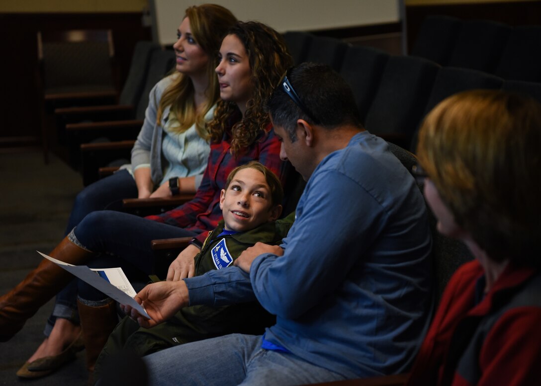 Ethan Ibi, pilot for a day, interacts with his dad March 9, 2018, at Eglin Air Force Base, Fla. The 33rd Fighter Wing hosted Ethan Ibi and his family for the "Pilot for a day" program. (U.S. Air Force photo by Airman 1st Class Emily Smallwood)