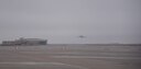A KC-135 Stratotanker takes off into a foggy sky