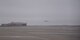 A KC-135 Stratotanker takes off into a foggy sky