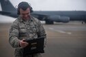 Tech. Sgt. Kurtis Woltemath, 931st Aircraft Maintenance Squadron crew chief, uses a technical order while performing aircraft launch procedures