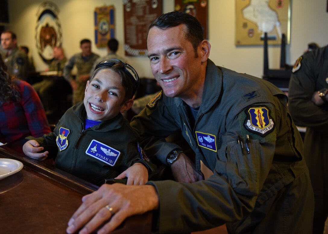 U.S. Air Force Col. Paul D. Moga, 33rd Fighter Wing commander, poses with "pilot for a day" Ethan Ibi March 9, 2018, at Eglin Air Force Base, Fla. The 33rd Fighter Wing hosted Ethan Ibi and his family for the "Pilot for a day" program. (U.S. Air Force photo by Airman 1st Class Emily Smallwood)