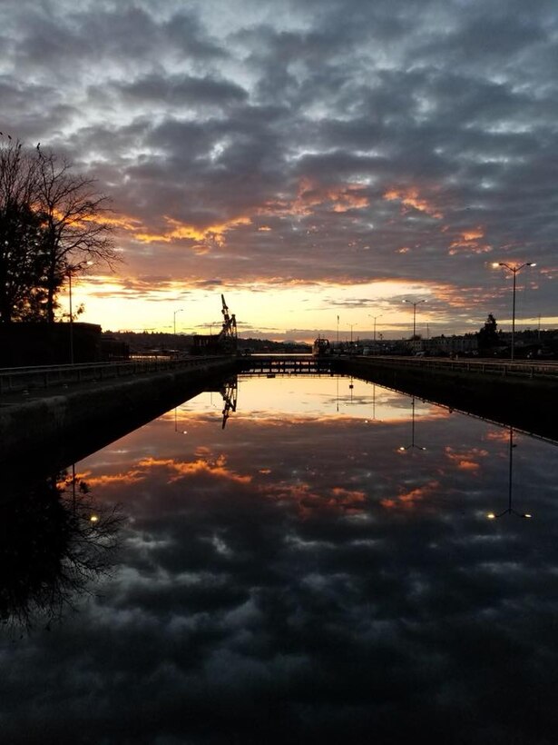 The sun rises as seen from the Hiram M. Chittenden Locks (Ballard Locks) March 11, 2018.