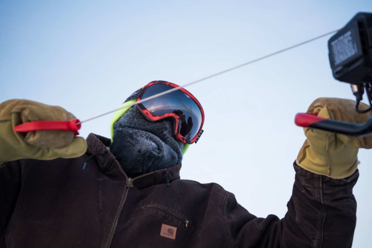 Members of Ice Camp Skate drill a hole in the ice in support of Ice Exercise 2018 in the Arctic Circle.