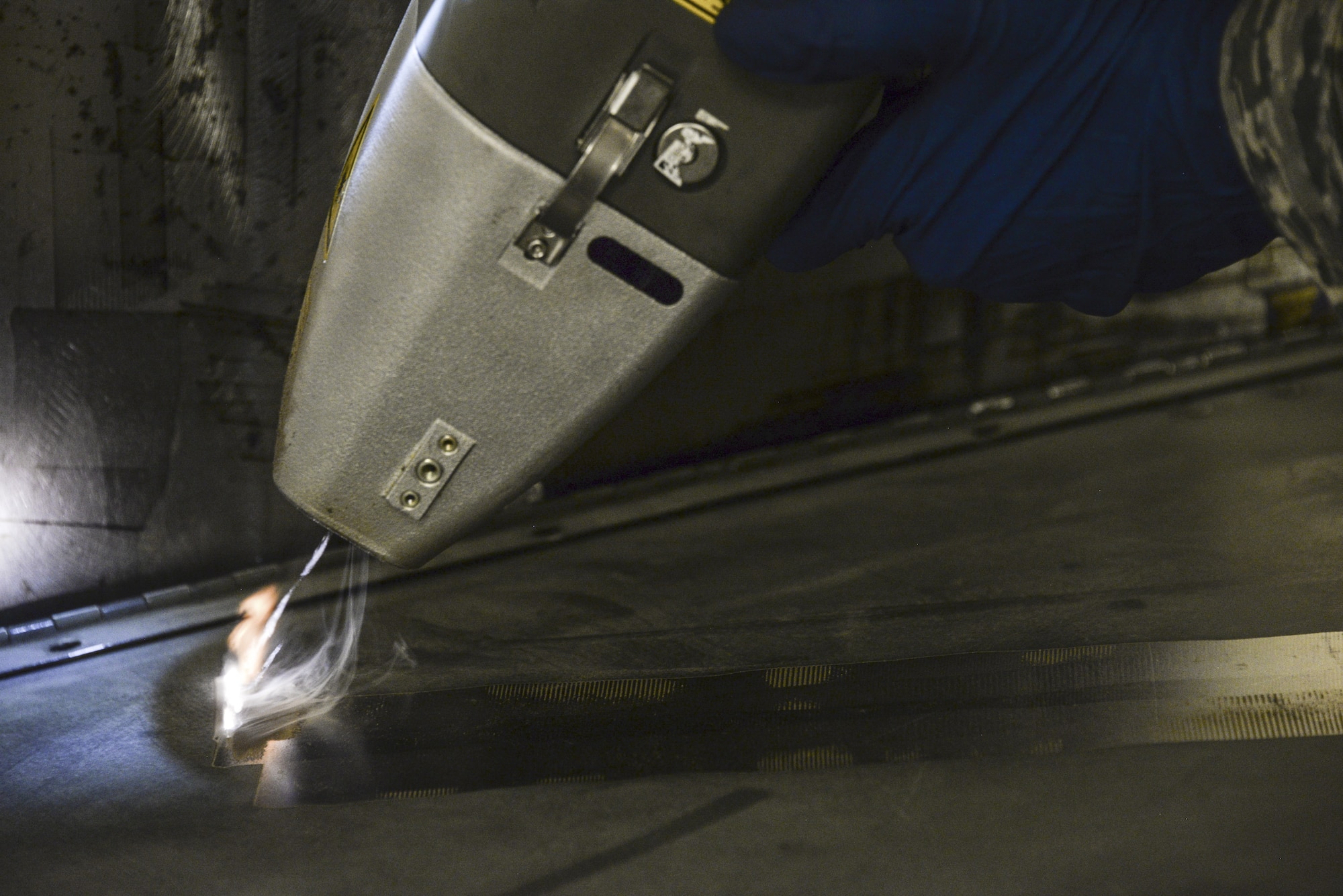 Airman 1st Class Levi Gordon, 60th Maintenance Squadron aircraft structural maintenance, uses a Clean Laser 1000 to remove paint from a sheet of metal March 7 at Travis Air Force Base, California. The 1000-watt laser can remove paint and corrosion. It reduces the waste created from sanding paint by 90 percent Travis was chosen as one of two bases to test the capabilities of the laser. (U.S. Air Force photos by Staff Sgt. Amber Carter)