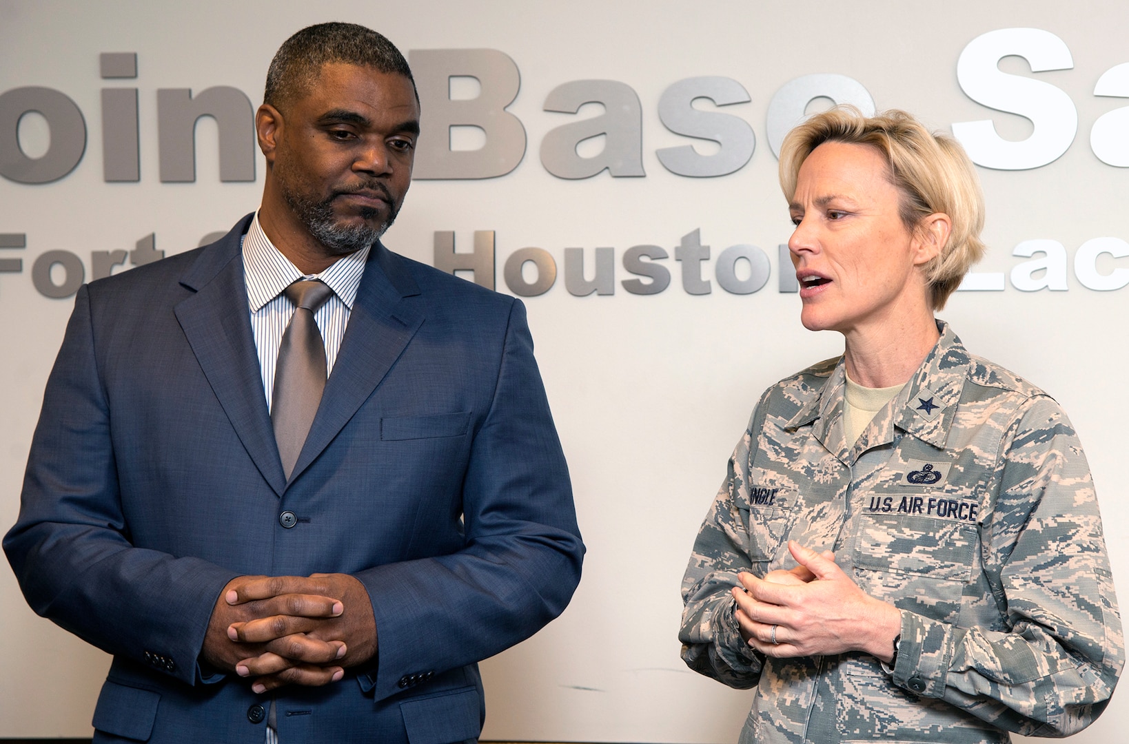 Brig. Gen. Heather Pringle (right), 502nd Air Base Wing and Joint Base San Antonio commander, thanks Garrick Williams (left), JBSA Energy Solutions director with CPS Energy, at the 502nd ABW headquarters at JBSA-Fort Sam Houston March 13, after he presented JBSA with a rebate check for $62,763.04.