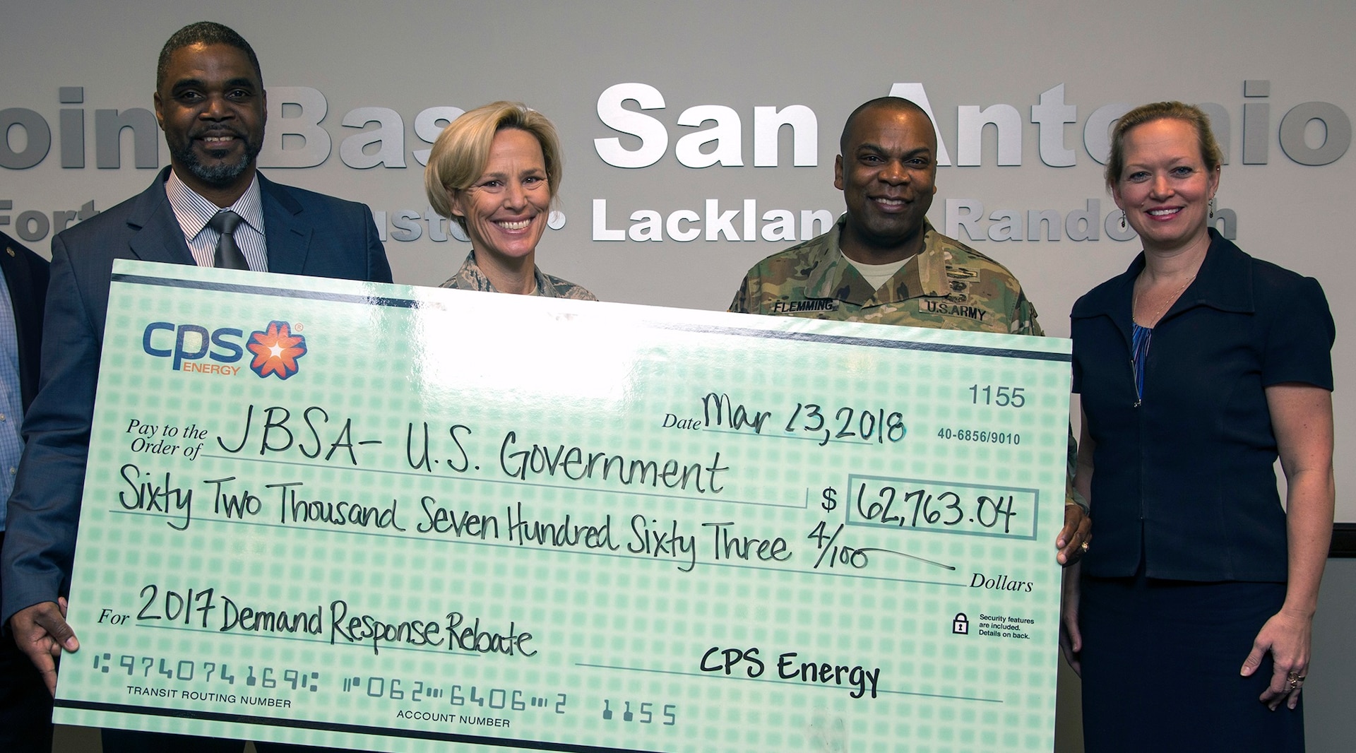 Garrick Williams (left), JBSA Energy Solutions director with CPS Energy, presents (from left) Brig. Gen. Heather Pringle (right), 502nd Air Base Wing and Joint Base San Antonio commander, Col. Lee Flemming, 502nd ABW and JBSA vice commander, and Brenda Roesch, 502nd Civil Engineer Squadron director, a rebate check for $62,763.04 at the 502nd ABW headquarters at JBSA-Fort Sam Houston March 13.