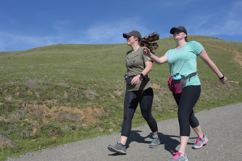 Tech. Sgt. Nikki Webb (Left), 60th Air Mobility Wing, hikes down a hill at Pena Adobe Regional Park in Vacaville, Calif., with her cousin, Senior Master Sgt. Jenny Hendry (Right), 60th Aeromedical Squadron, March 11, 2018. Hendry joined Webb on a 10-mile hike as she prepares for the Bataan Memorial Death March on March 25. (U.S. Air Force photo/Tech. Sgt. James Hodgman)