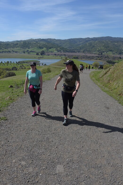 Senior Master Sgt. Jenny Hendry (Left), 60th Aeromedical Squadron, hikes up a hill at Pena Adobe Regional Park in Vacaville, Calif., with her cousin, Tech. Sgt. Nikki Webb (Right), 60th Air Mobility Wing, March 11, 2018. Hendry joined Webb on a 10-mile hike as she prepares for the Bataan Memorial Death March on March 25. (U.S. Air Force photo/Tech. Sgt. James Hodgman)