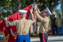 U.S. Marine Corps Sgt. Maj. William T. Sowers, left, the sergeant major, and Maj. Gen. Eric Smith, the commanding general, both of 1st Marine Division, add a streamer to the division colors during the units 77th anniversary ceremony at Marine Corps Base Camp Pendleton, Calif., Feb. 2, 2018.
