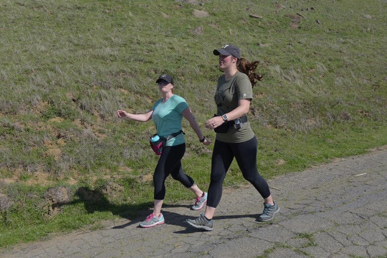 Senior Master Sgt. Jenny Hendry (Left), 60th Aeromedical Squadron, hikes up a hill at Pena Adobe Regional Park in Vacaville, Calif., with her cousin, Tech. Sgt. Nikki Webb, 60th Air Mobility Wing, March 11, 2018. Hendry joined Webb on a 10-mile hike as she prepares for the Bataan Memorial Death March on March 25. (U.S. Air Force photo/Tech. Sgt. James Hodgman)