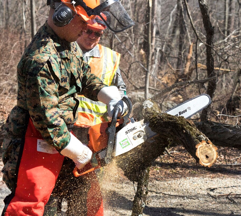 A Marine Corps reservist practices operating a chainsaw.