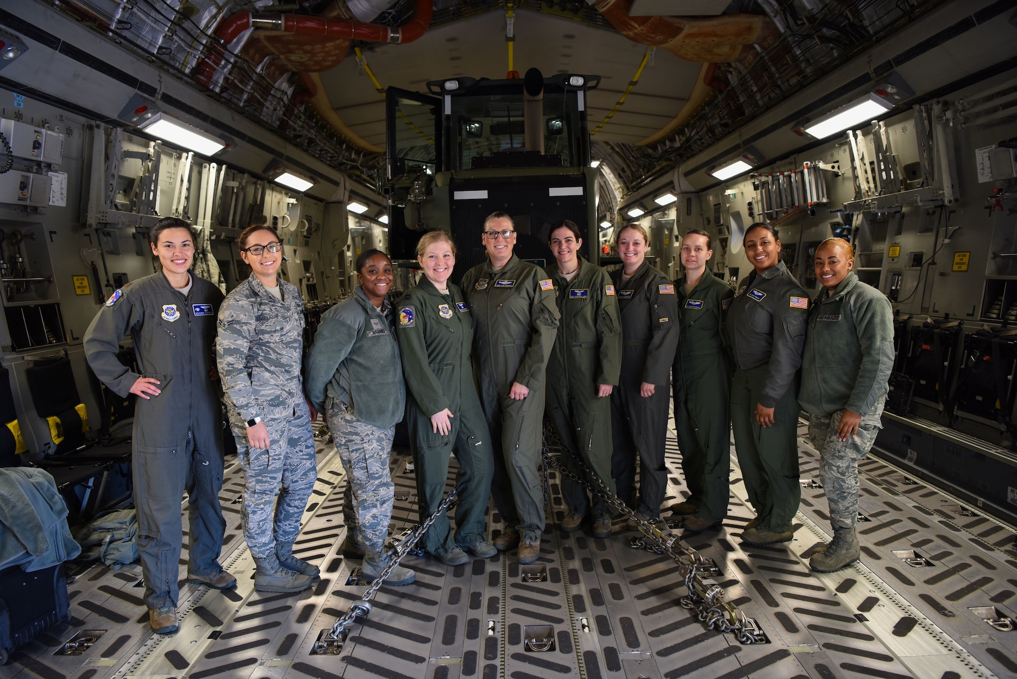 From the left, Maj. Giovanna Espegio, Airman 1st Class Rebeckah Eggleston, Senior Airman Jasmene Barnes, Capt. Taylor Stephens, Senior Master Sgt. Lori Tascione, Staff Sgt. Cassandra LaVoie, 1st Lt. Hannah Wiesneski, Senior Airmen Daneile Belovarac, Airman 1st Class Casey McCune and Senior Airman Taylar Moe stand on the cargo deck of a C-17 Globemaster III March 5, 2018, at Dover Air Force Base, Del. The all-female crew flew a local mission in honor of Women’s History Month and Tascione’s retirement. (U.S. Air Force Photo by Airman 1st Class Zoe M. Wockenfuss)