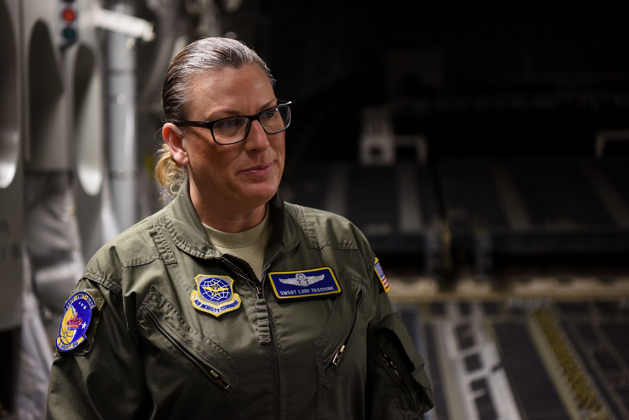Senior Master Sgt. Lori Tascione, 3rd Airlift Squadron superintendent, prepares for a flight March 5, 2018, at Dover Air Force Base, Del. Tascione flew as the loadmaster for the mission that was her final flight before her retirement. (U.S. Air Force Photo by Airman 1st Class Zoe M. Wockenfuss)