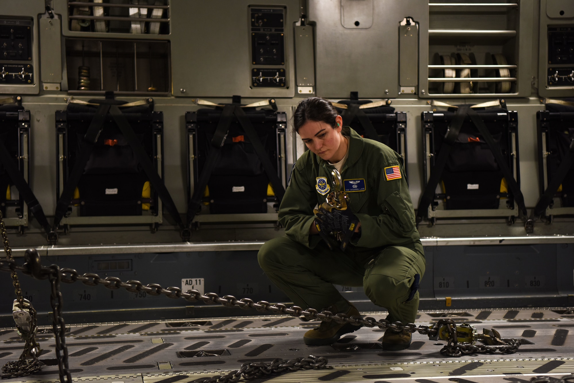 Staff Sgt. Cassandra LaVoie, 3rd Airlift Squadron loadmaster, checks the movement restricting chains aboard a C-17 Globemaster III before flight March 5, 2018, at Dover Air Force Base, Del. LaVoie was a member of an all-female C-17 crew that flew a local mission in honor of Women’s History Month. (U.S. Air Force Photo by Airman 1st Class Zoe M. Wockenfuss)