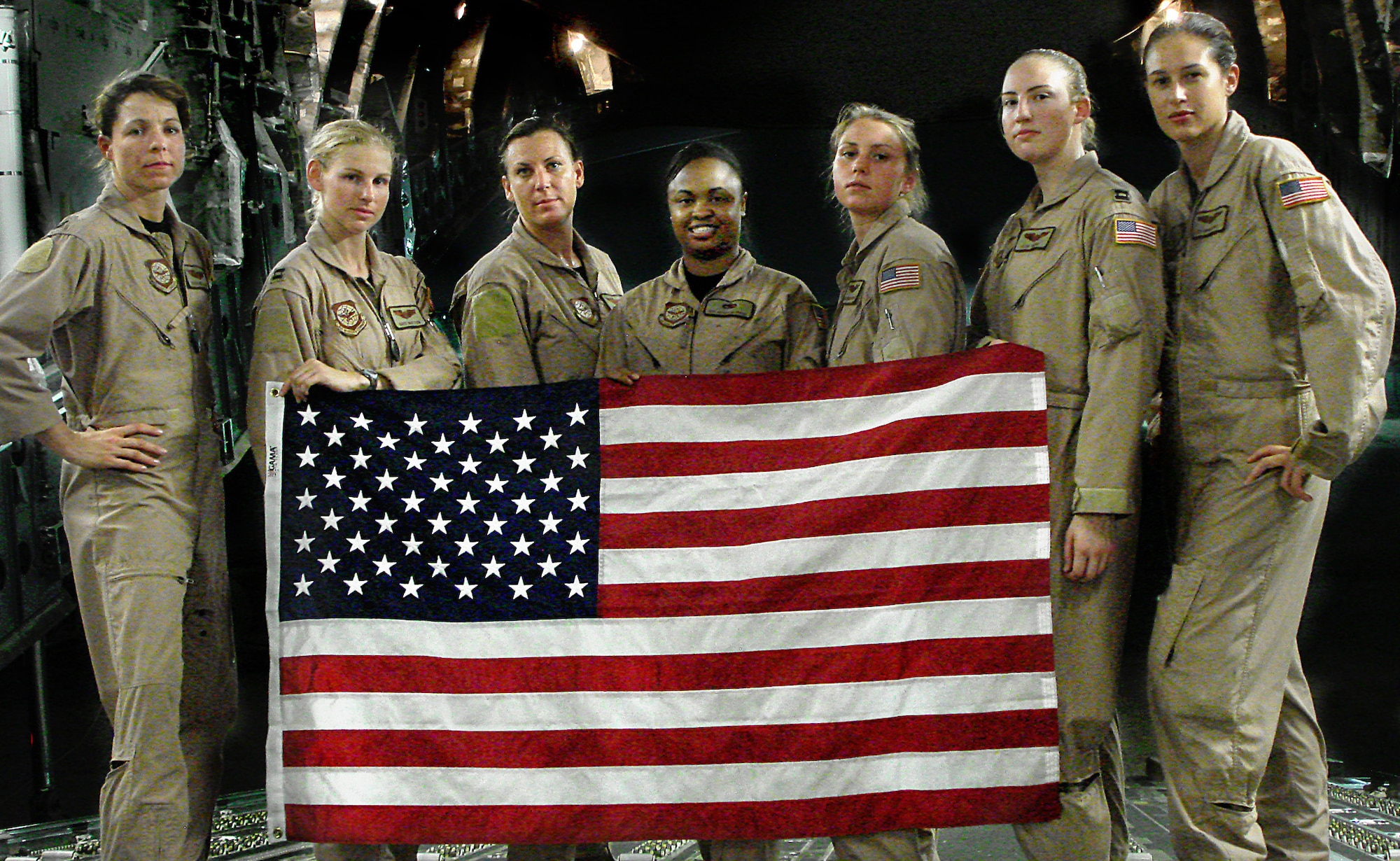 Third from the left, then Tech. Sgt. Lori Tascione, 816th Expeditionary Airlift Squadron loadmaster, took part in the first all-female C-17 Globemaster III flight in July 2007. Tascione recently ended her career with another all-female C-17 flight. (Courtesy photo)