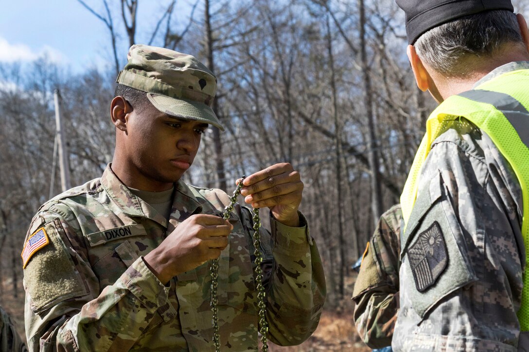 A soldier inspects a new cutting chain.
