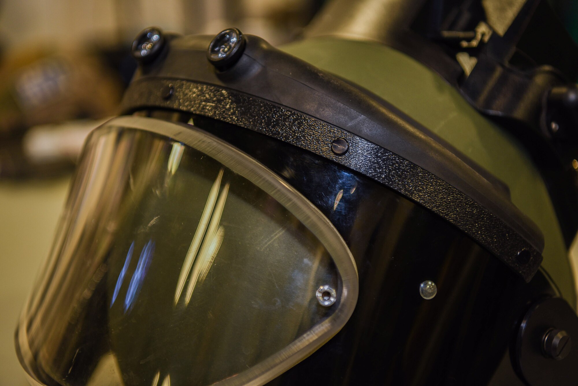 As a 90th Civil Engineering Squadron Explosive Ordinance Disposal technician, one can expect to wear a bomb suit at some point during their career at F.E. Warren Air Force Base, Wyo., Feb. 27, 2018. The helmet has a glass shield to allow the Airmen inside the suit to see the area of response and potential threat. The 85-pound suit magnifies every issue the Airman faces, but there is always a team behind them to help prevent any dangerous situations. (U.S. Air Force photo by Airman 1st Class Abbigayle Wagner)