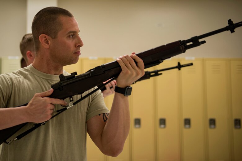 Tech. Sgt. Dallas Ayers, 823d Base Defense Squadron assistant flight chief, practices drills in a firing party, March 2, 2018, at Moody Air Force Base, Ga. Ayers is preparing to make the transition from protecting lives in combat to honoring the Air Force. He was recently selected for the U.S. Air Force Honor Guard and will begin his honor guard technical school April 16. (U.S. Air Force photo by Airman 1st Class Erick Requadt)