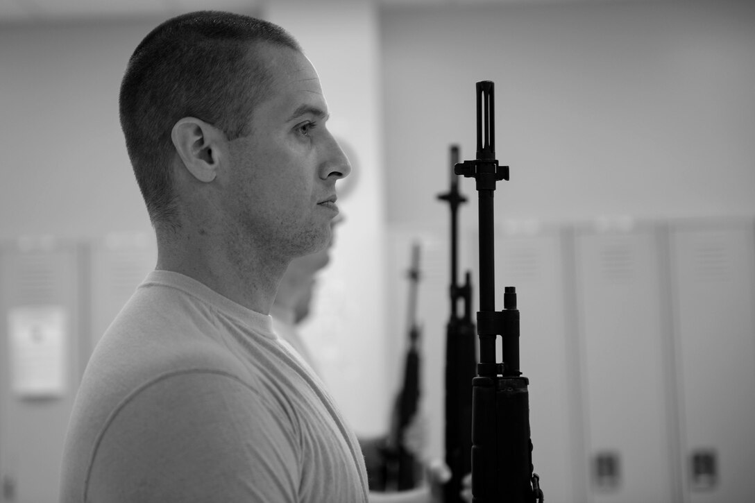 Tech. Sgt. Dallas Ayers, 823d Base Defense Squadron assistant flight chief, presents arms using his rifle, March 2, 2018, at Moody Air Force Base, Ga. Ayers is preparing to make the transition from protecting lives in combat to honoring the Air Force. He was recently selected for the U.S. Air Force Honor Guard and will begin his honor guard technical school April 16. (U.S. Air Force photo by Airman 1st Class Erick Requadt)