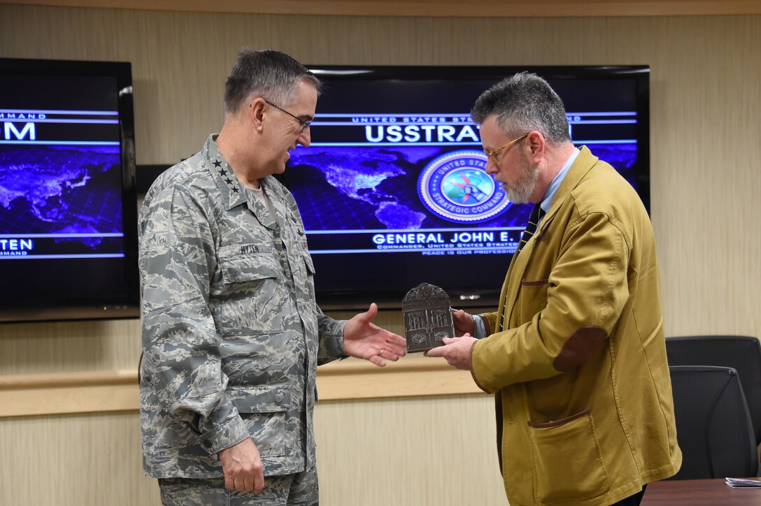 Dr. Michael Desch (right), director of Notre Dame International Security Center (NDISC), presents Gen. John Hyten, commander of U.S. Strategic Command (USSTRATCOM), with a memento at Offutt Air Force Base, Neb., March 13, 2018.