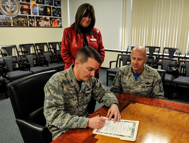 Col. Jeff Nelson, 628th Air Base Wing commander, signs a 2018 Military Saves Week proclamation March 9, 2018, at Joint Base Charleston.