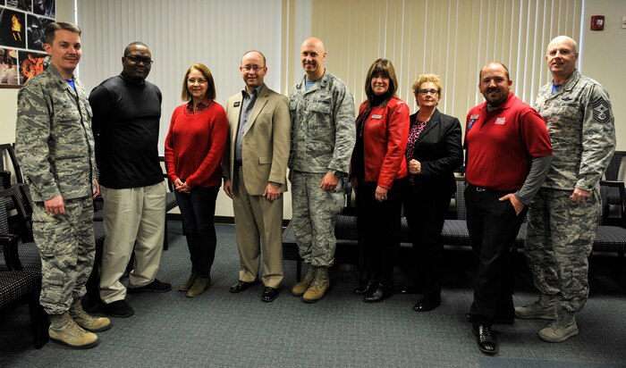 Col. Jeff Nelson, left, 628th Air Base Wing commander, left, and Chief Master Sgt. Todd Cole, 628th Air Base Wing command chief, right, pose for a photo with supporters of Military Saves Week March 9, 2018, at Joint Base Charleston, S.C.
