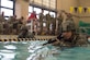 U.S. Army Sgt. Ian Lubert, 689th Rapid Port Opening Element, 832nd Transportation Battalion, 597th Transportation Brigade cargo specialist, swims in full gear at Anderson Field House at Joint Base Langley-Eustis, Virginia, March 1, 2018. The competition was part of the brigade's week-long Rapid Support Challenge. (U.S. Air Force photo by Airman 1st Class Monica Roybal)