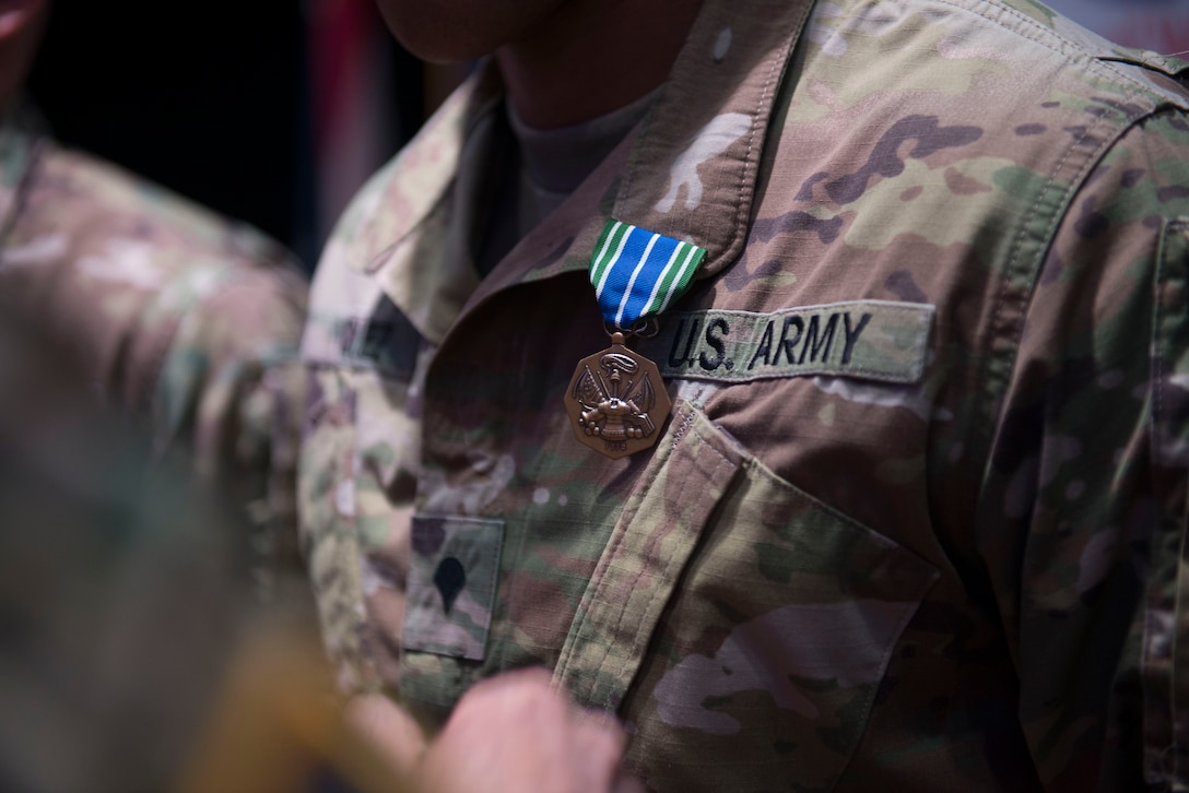 A U.S. Army Soldier wears an Army achievement medal in Wylie Theater at Joint Base Langley-Eustis, Virginia, March 1, 2018. The award ceremony concluded the week-long 597th Trans. Bde. Rapid Support Challenge. (U.S. Air Force photo by Monica Roybal)