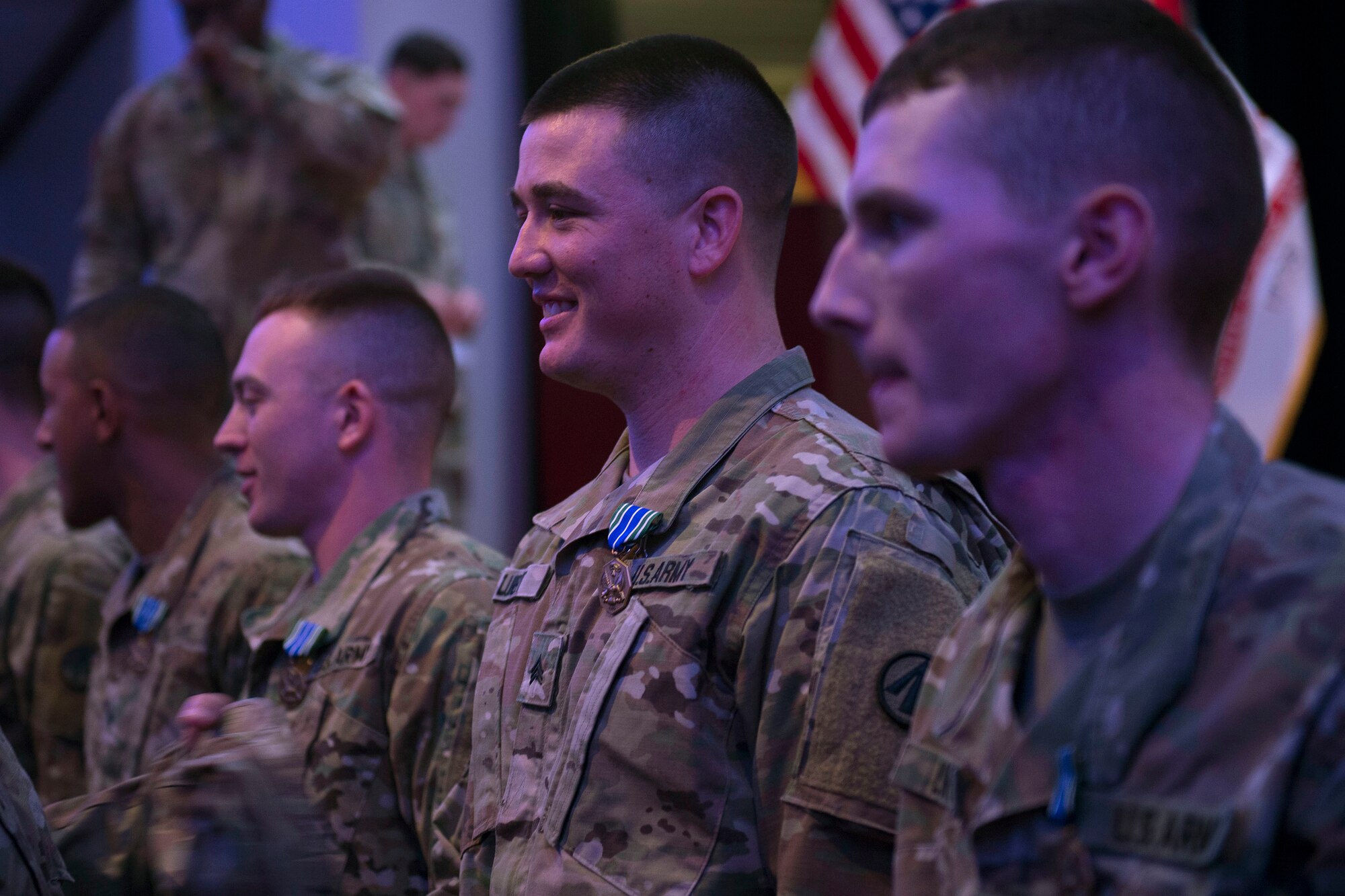 U.S. Army Sgt. Ian Lubert, 689th Rapid Port Opening Element, 832nd Transportation Battalion, 597th Transportation Brigade cargo specialist, receives a U.S. Army achievement medal in Wylie Theater at Joint Base Langley-Eustis, Virginia, March 1, 2018. Soldiers who competed in the 597th Trans. Bde. Rapid Support Challenge received the medal and a certificate of recognition. (U.S. Air Force photo by Monica Roybal)