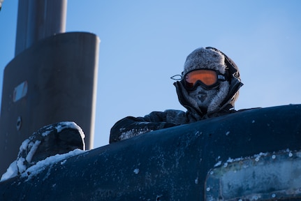 180316-N-KC128-269 Ice Camp Skate (March 16, 2018) – Chief Hospital Corpsman Kristopher Mandaro, assigned to Underwater Construction Team One (UCT 1), surfaces from a waterhole during a torpedo exercise in the Arctic Circle in support of Ice Exercise (ICEX) 2018, March 16. ICEX 2018 is a five-week exercise that allows the Navy to assess its operational readiness in the Arctic, increase experience in the region, advance understanding of the Arctic environment, and continue to develop relationships with other services, allies and partner organizations. (U.S. Navy photo by Mass Communication Specialist 1st Class Daniel Hinton)
