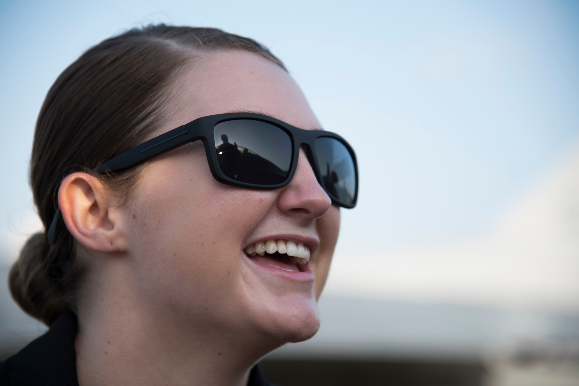 U.S. Air Force Senior Airman Emily Wall, a Pacific Air Forces' Demonstration Team crew chief, watches a team member clean the canopy prior to a demonstration at Paya Lebar Air Base, Singapore, Feb. 3, 2018. Growing up with five brothers and a sister, who all worked high-class careers, Wall stood out from her siblings by using the Air Force to make a difference in other females' lives by encouraging them to do great things in the military. (U.S. Air Force photo by Senior Airman Sadie Colbert)